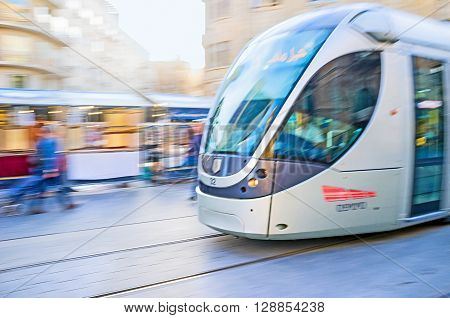 JERUSALEM ISRAEL - FEBRUARY 18 2016: The tram in motion riding along the Yafo Road on February 18 in Jerusalem.