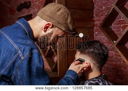Haircut men Barbershop. Men's Hairdressers; barbers. Barber cuts the client machine for haircuts.