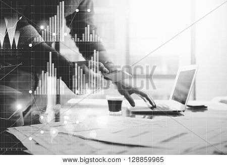 Business concept photo.Meeting of investment managers.Woman showing repots.Man using modern laptop. Graphic icon, worldwide stock exchanges interfaces. Horizontal. Film effect. Black and White