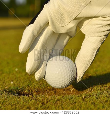 green field and white golf ball sport sanset