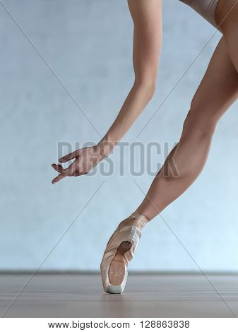 Young beautiful ballerina posing in ballet class