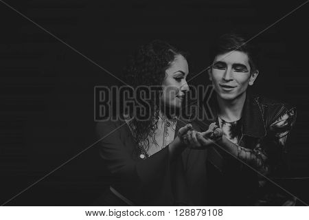 Acting. Man and woman in an interesting way on a dark background.
