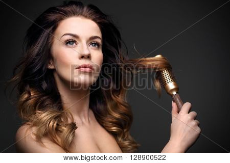 Laying, modeling hair on a round brush.