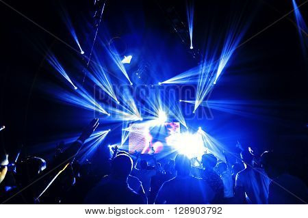 night party concert crowd of people silhouettes hands up