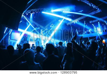 night party concert crowd of people silhouettes hands up