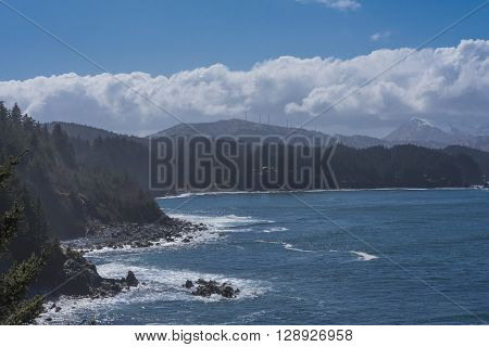 The Pacific Ocean crashing into the bluffs along the Alaskan Coast