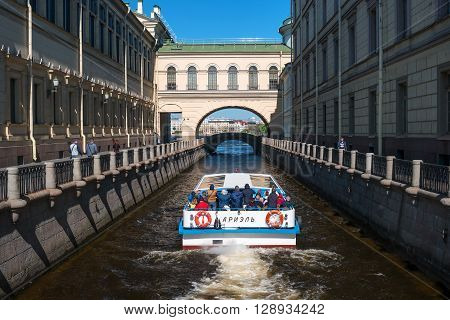 St. Petersburg Russia - May 8 2016: Tourist boat moves along the Winter Canal near the Hermitage. It is a popular trip in the city