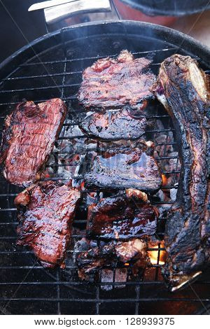 fresh red grilled beef meat fillet asado on deep round bbq grill over fire
