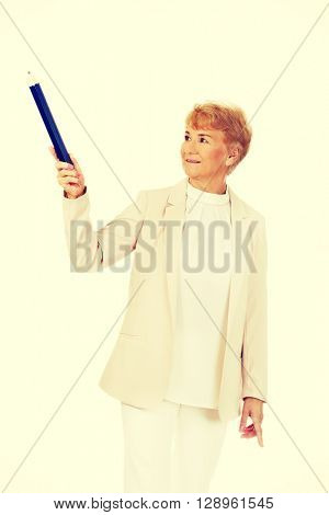 Smile elderly woman pointing up with hege pen