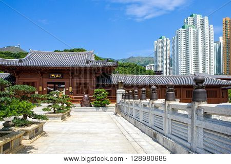 Hong Kong the Chi Lin antique monastry and in the background the towers of the new Kowloon quarter
