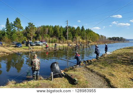 MIDDLE URALS RUSSIA - MAY 5 2016: Many fishermen catch fish in the mouth of the river Kanava during the spring fishing activity. Middle Ural. Russia