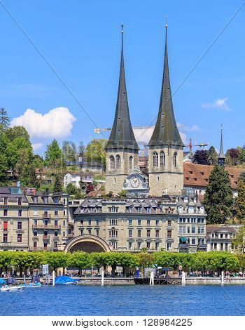 Lucerne, Switzerland - 8 May, 2016: view on Kurplatz square with the towers of the Church of St. Leodegar in the background. The Church of St. Leodegar is the most important church and a landmark of the city.