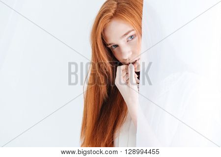 Closeup portrait of attractive redhead woman lookin at camera