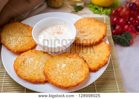 draniki - grilled Pancakes with sourcream on the plate