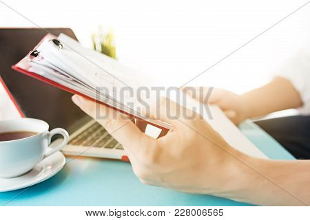 Male Hands Holding Pen, Writing. Side View On Man On Trendy Color Blue Desk. Man And Stilish Workpla