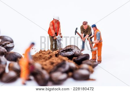 Miniature Figures Working On Coffee Macro Photography On White Background