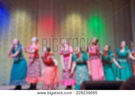 Folk Dances Of Children And Teens Theme Abstract Blur Background With Bokeh Effect. Teens In Bright 
