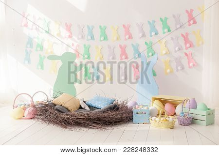 Colorful Easter Eggs In Nest From And Baskets With Space For Copy Text On Wall Background