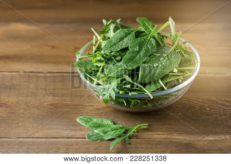 Bowl With Fresh Green Aragula And Spinach On Wooden Background Mix With Spinach Rucola Copy Space He