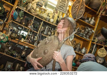 Akaba, Jordan -december 23, 2017: Female Tourist Is Buying A Souvenirs In An Antique Shop