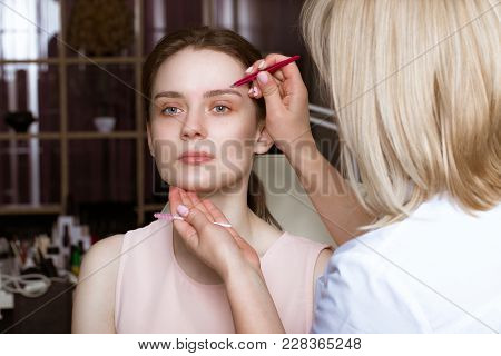 Permanent Microblasting Tattooing Freckles To A Woman In A Beauty Salon.