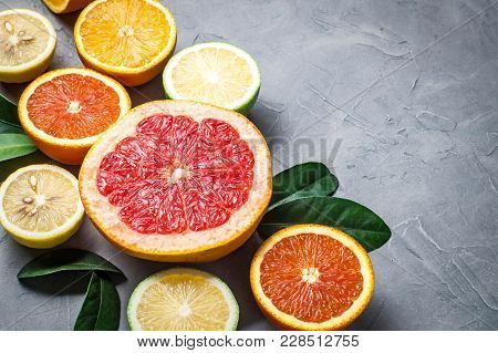 Raw Food: Slicing Citrus Fruits. Orange, Tangerine, Lemon Lime Grapefruit Close-up