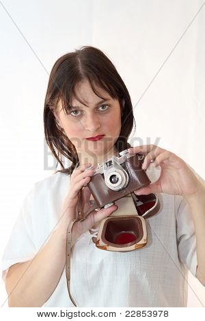 A Female Brunette Model Wearing An Old Camera