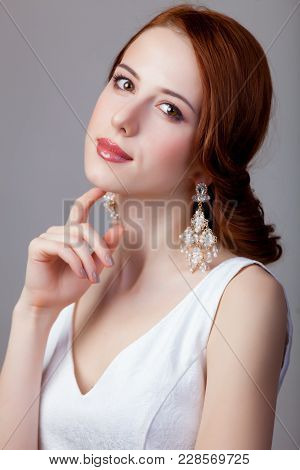 Portrait Of Young Redhead Woman With Breautiful Earrings