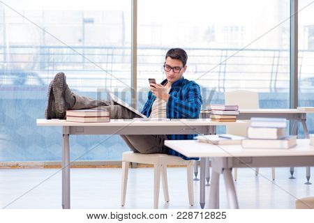 Student studying in the empty library with book preparing for ex