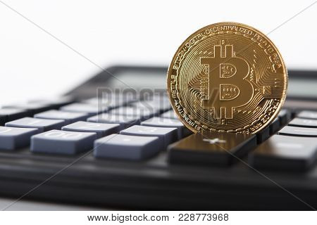 Bitcoin On The Keyboard Of The Calculator. Shallow Depth Of Field. A Visual Representation Of Digita