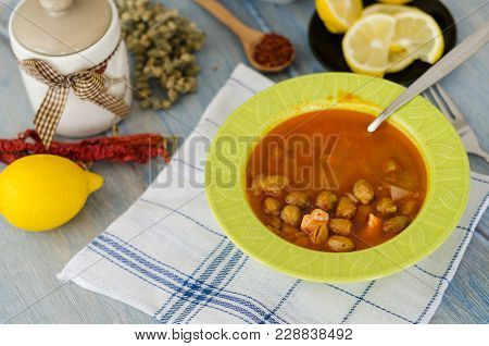 Homemade Bombo Soup In A Green Bowl With On A Wooden Table.