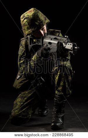 Portrait Of Armed Woman With Camouflage. Young Female Airsoft Sniper Observe With Firearm. Soldier W