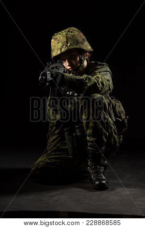 Portrait Of Armed Woman With Camouflage. Young Female Airsoft Sniper Observe With Firearm. Soldier W
