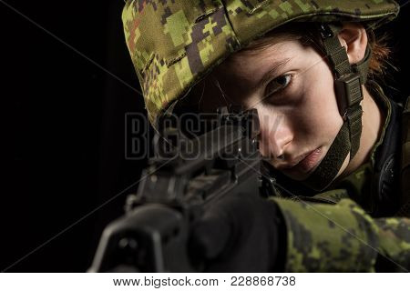 Portrait Of Armed Woman With Camouflage. Young Female Airsoft Sniper Observe With Firearm. Soldier W