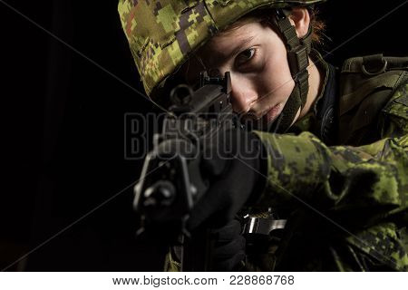 Portrait Of Armed Woman With Camouflage. Young Female Airsoft Sniper Observe With Firearm. Soldier W