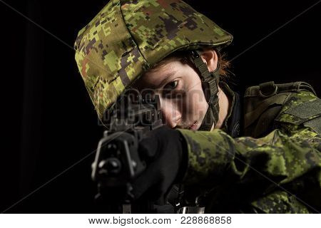 Portrait Of Armed Woman With Camouflage. Young Female Airsoft Sniper Observe With Firearm. Soldier W