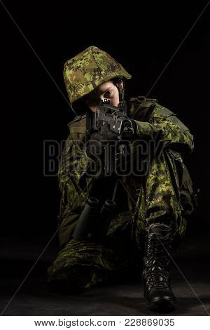 Portrait Of Armed Woman With Camouflage. Young Female Airsoft Sniper Observe With Firearm. Soldier W