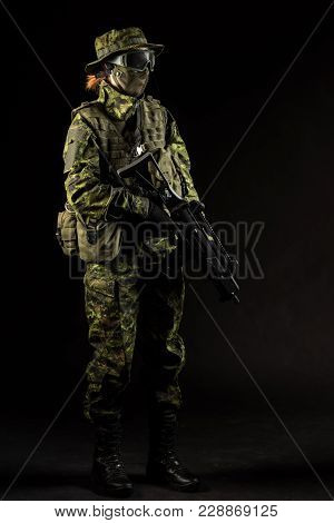 Portrait Of Armed Woman With Camouflage. Young Female Airsoft Sniper Observe With Firearm. Soldier W