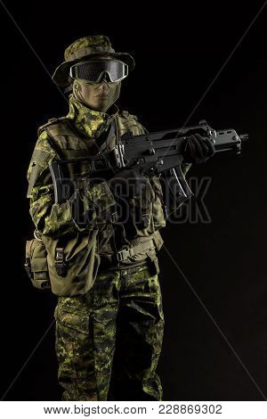 Portrait Of Armed Woman With Camouflage. Young Female Airsoft Sniper Observe With Firearm. Soldier W