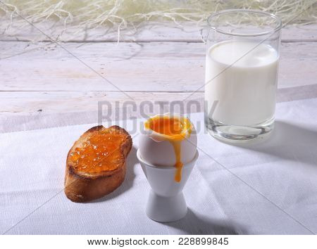 Healthy Morning Breakfast Set With Egg, Orange Jam On Bread Toast And Milk In Glass