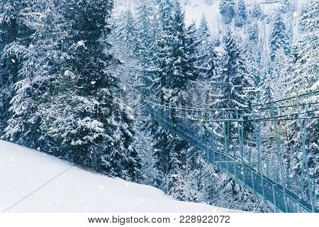 Pedestrian Suspension Bridge In Sattel Lucerne Region Switzerland. Winter Landscape.