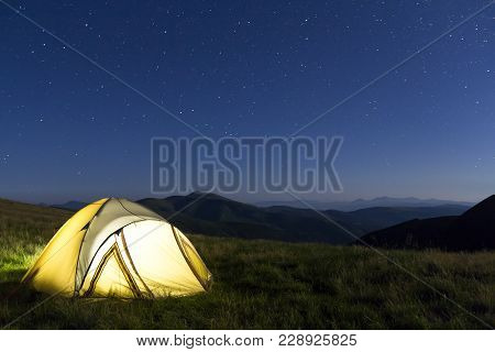 Tourist Hikers Tent In Mountains At Night With Stars In The Sky