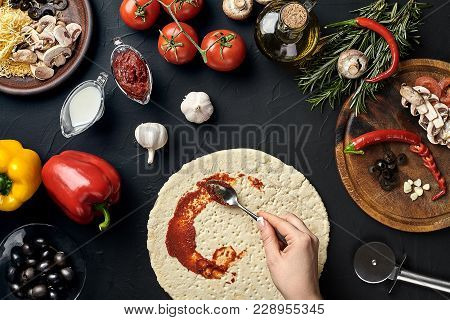 Hands Of Baker Adding Ingredients Into Pizza During Pizza Preparation At Kitchen. Mushrooms, Tomatoe