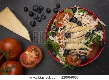 Fresh Salad With Chicken, Tomatoes Blueberries And Parmesean Cheese