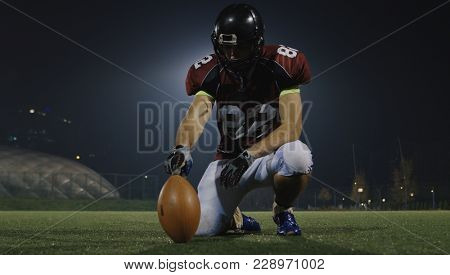 american football kicker ready for football kickoff closeup shot on the night field