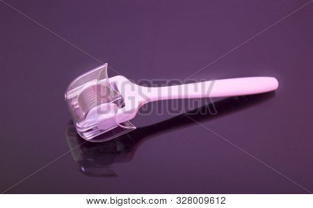 Mezoroller, Dermaroller, Mesotherapy Skin Tool. A Mesoroller With A White Handle And A Pink Rabbit O
