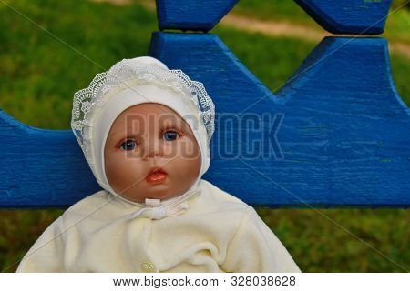 Beautiful Doll As A Living Baby On Outsite Bench. Favorite Toy Girls.