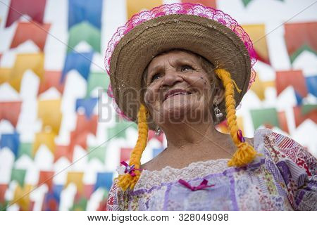 Caruaru, Pernambuco, Brazil - July 11, 2016: Woman With Traditional Clothing Under Colorful Pennants