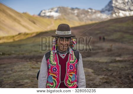 Vinicunca, Cusipata, Peru - June 08, 2017: Peruvian Andean Man Wearing Traditional Colorful Clothing