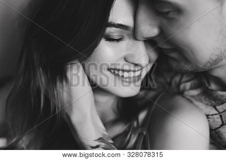 Kissing Couple Portrait. Young Couple Deeply In Love Sharing A Romantic Kiss. Black And White Photo